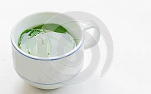The soft blurred and soft focus cup of green tea, Kariya , The Creat,Andrographis paniculata,Acanthaceae,leaf plant with the white
