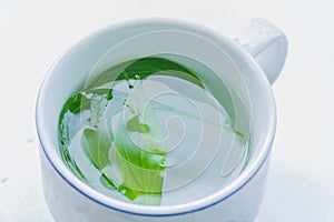 The soft blurred and soft focus cup of green tea, Kariya , The Creat,Andrographis paniculata,Acanthaceae,leaf plant with the white