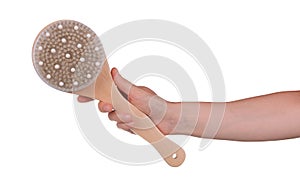 Soft body massage brush in female hand isolated on white