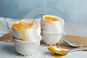Soft boiled chicken eggs on white table