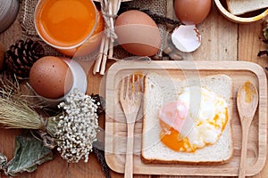 Soft-boiled egg with bread on wood background.