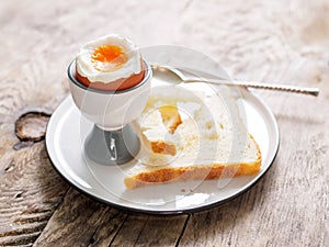 Soft boiled egg in Cup on a wooden table