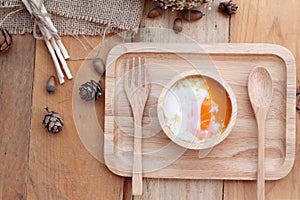 Soft-boiled egg and eggs on wood background