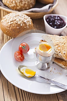 Soft-boiled egg in the morning with pepper, tomatoes and crouton