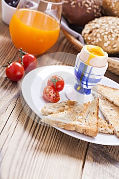 Soft-boiled egg in the morning with pepper, tomatoes and crouton