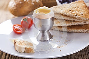 Soft-boiled egg in the morning with pepper, tomatoes and crouton