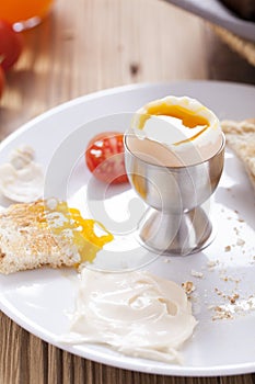 Soft-boiled egg in the morning with pepper, tomatoes and crouton