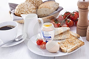 Soft-boiled egg in the morning with toast. In the background of