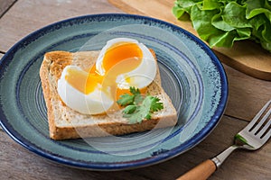 Soft boiled egg with toast on blue plate