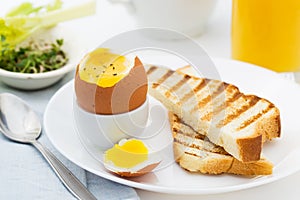 Soft boiled egg with toast for rich breakfast.