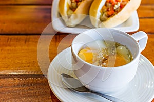 Soft boiled egg in white cup with pepper and spoon