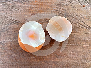 Soft boiled egg with yolk on wooden table background