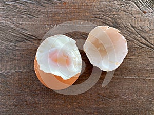 Soft boiled egg with yolk on wooden table background