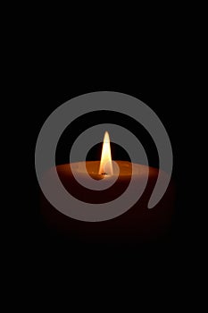 Soft candle light in total darkness with copy space