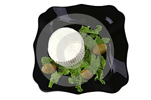 Soft cheese on black dish