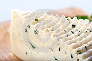 Soft cheese sector with herbs close-up
