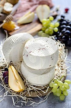 Soft cheeses with grapes, pears and honey