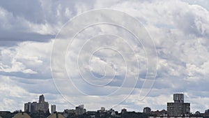 Soft clouds moving over buildings residential area drone shot. Majestic nature