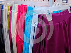Soft Colorful Pants Hanging on the Rack For Sale at Clothing Store