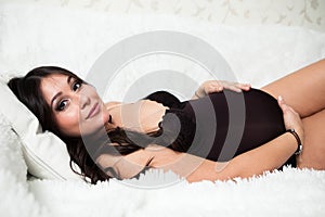 Soft and comfortable. Top view of attractive young woman lying in bed and keeping eyes closed while covered with blanket