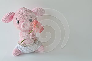 Soft crochet animal holding a flower