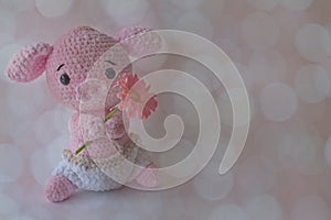 Soft crochet animal a holding flower