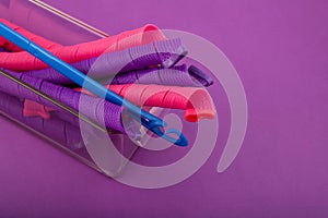Soft Curler Spiral or Long hair rollers ahd hook in plastic box on purple background. Fashion accessories for frizzle photo