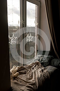 Cozy Pillows on Window Seat with Warm Lights