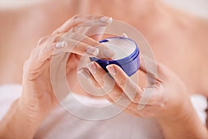 Soft dream cream. Cropped studio shot of a mature woman applying moisturizer.