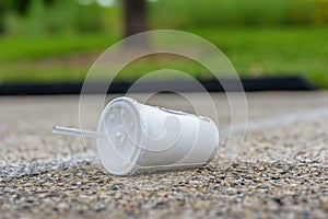Soft drink cup litter on pavement