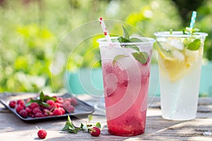 SOFT DRINKS. Refreshing summer drink lemon with mint, ice and raspberry with basil, ice.