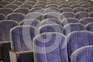 Soft empty chairs in the auditorium
