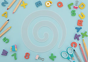 Soft English letters and numbers with school and office supplies on blue background. Back to school, stationary concept. Kid`s se