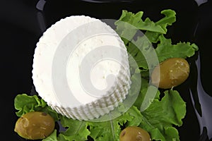 Soft feta cheese on black dish