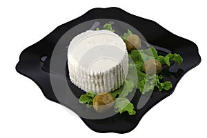 Soft feta cheese on black dish