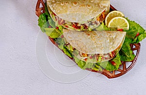 Soft flour tortillas stuffed with lettuce, meat and vegetable on white background