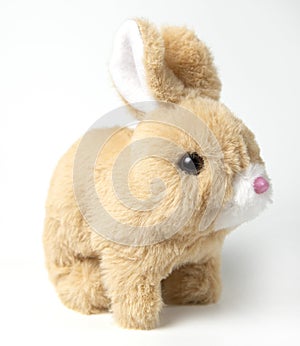 Soft fluffy rabbit toy with long ears, isolated on a white background