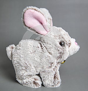 Soft fluffy rabbit toy with long ears, isolated on a white background