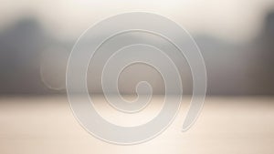 Soft focus abstract background with blurred bokeh lights and muted neutral tones creating a gentle atmosphere