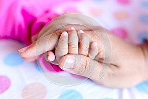 Soft focus of baby hands and mom, New family and baby protection concept, baby in the hand of mother close up, Parent holds Baby