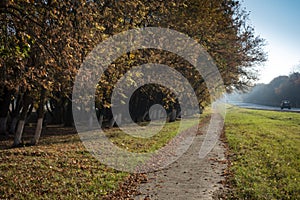 Soft focus background of asphalt road and car in a rural autumn landscape at sunset