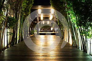 Soft focus of black wooden garden path with bamboo on both side