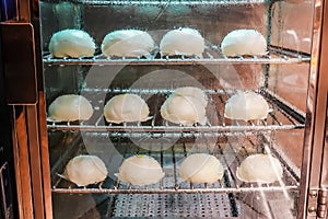 Soft focus chinese pork bun or steamed dumpling in steam cabinet warming for sale ready to eat in mini mart , Chinese food