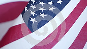 Soft focus close up of American Old Glory flag waving on wind. Stars and Stripes democracy, patriotism, freedom and