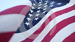 Soft focus close up of American Old Glory flag waving on wind. Stars and Stripes democracy, patriotism, freedom and Independence