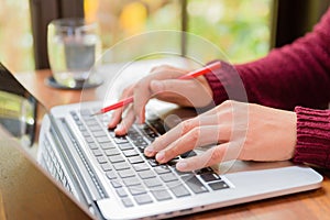 Soft focus Closeup woman hand working on her laptop.