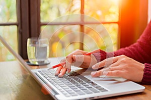 Soft focus Closeup woman hand working on her laptop.