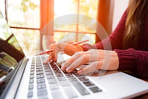 Soft focus Closeup woman hand working on her laptop. Social networking technology concept.