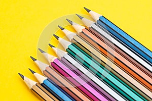 Soft focus on colorful pencils on solid yellow background with copy space using as writing ideas, variant or color art concept photo