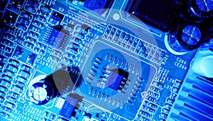 Soft focus. Concept of micro chips in blue backlight. Detail of microchips on an electronic circuit board.